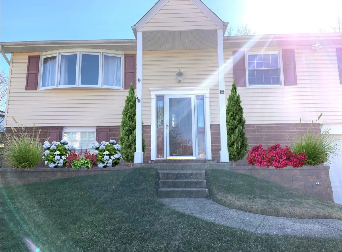 Front entry after landscape rendering with arborvitae and grasses