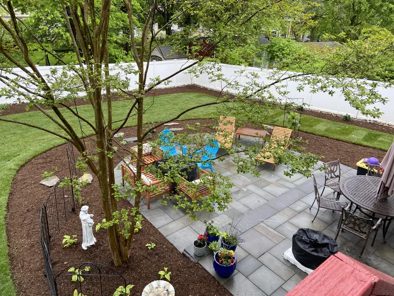 Backyard patio with dark mulch beds and landscaping in Anne Arundel County